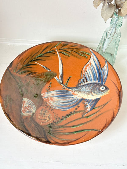 Mid century Puigdemont La Bisbal charger with hand painted fish in blue and white on orange glaze