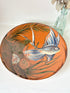 Mid century Puigdemont La Bisbal charger with hand painted fish in blue and white on orange glaze