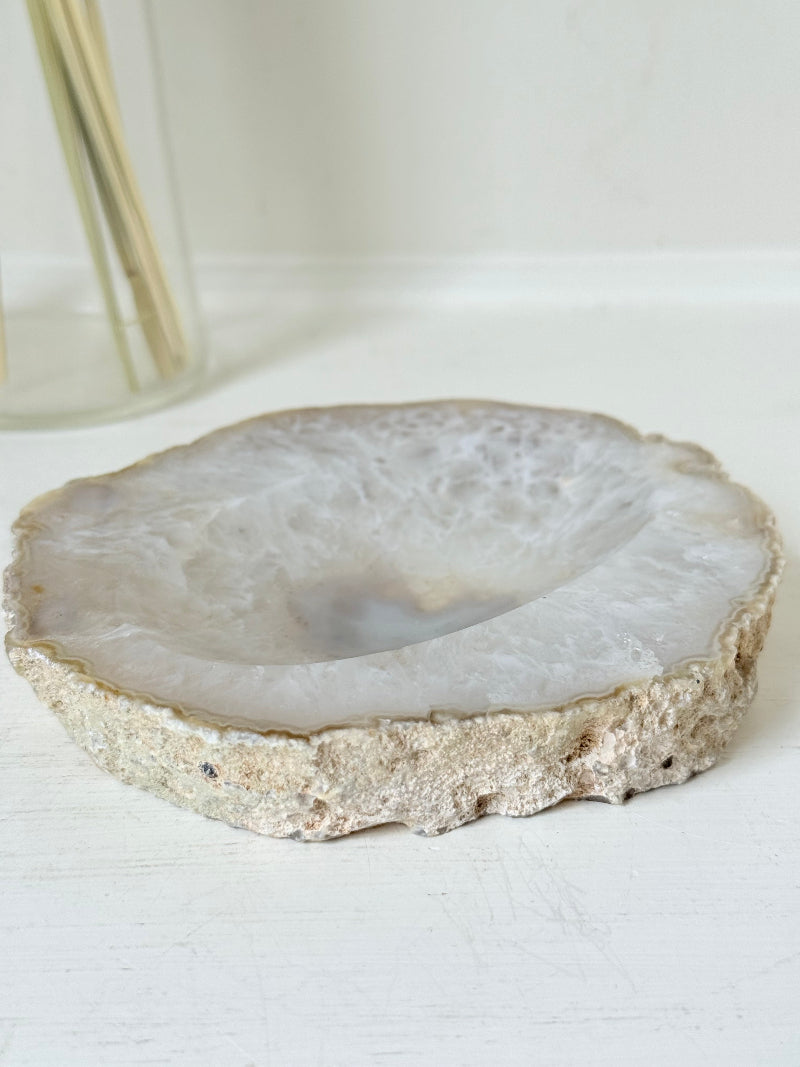 Vintage natural agate stone soap dish in grey and white, photographed on a white surface.