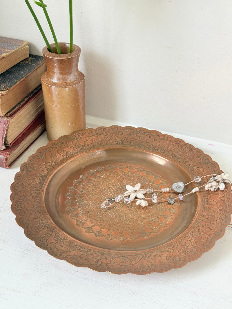 Vintage hand engraved copper tray with scalloped edge, bird and floral motif and warm aged patina for boho interiors