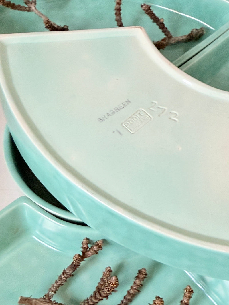 Poole Pottery turquoise hors d’oeuvre dishes set of five displayed on a white surface.