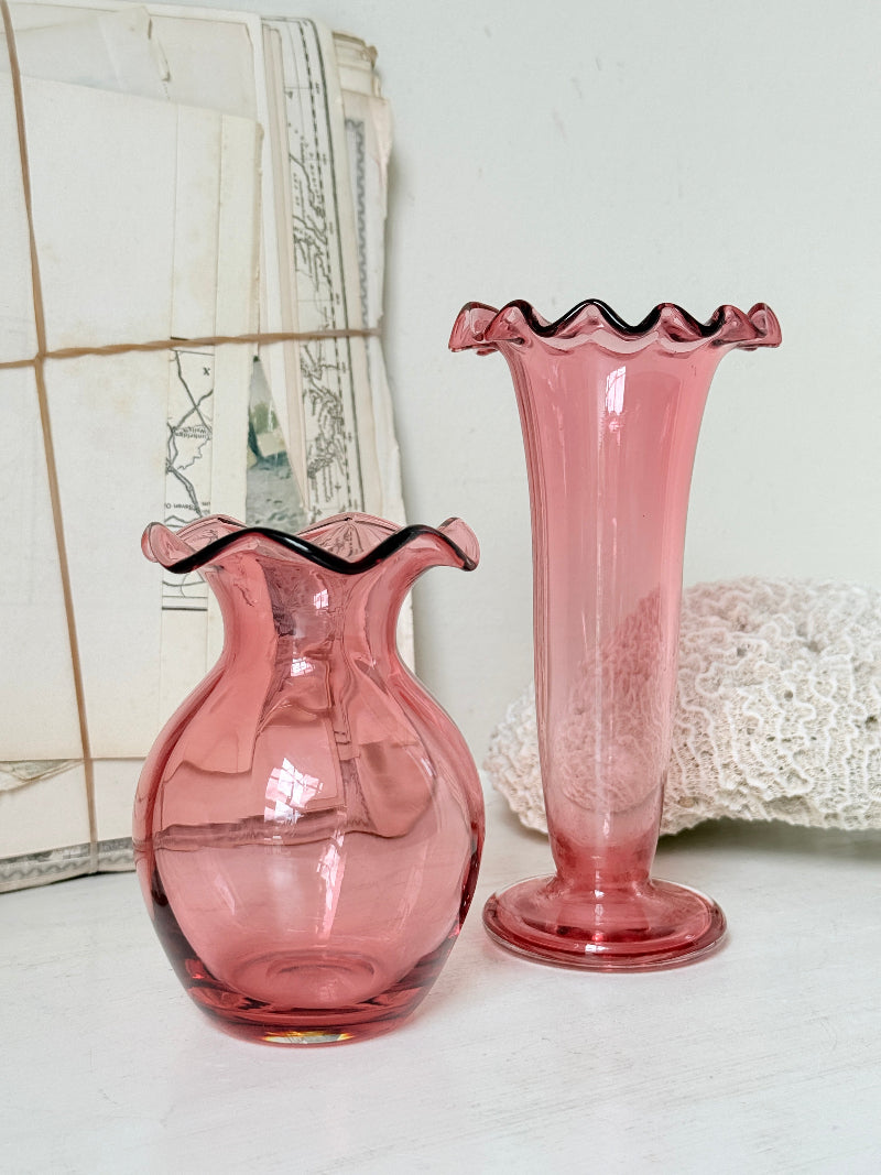 Pair of cranberry glass vases with crimped frill rims, trumpet vase and bulbous bud vase in soft pink glass