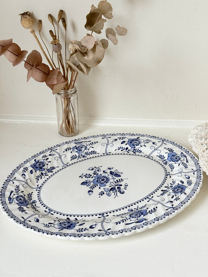 Vintage Johnson Brothers Indies blue and white oval serving platter photographed on a white surface