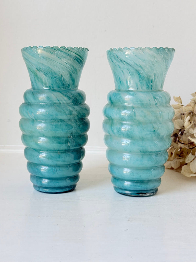 Pair of vintage aqua blue glass vases with beehive pattern and scalloped edges, photographed on a white surface