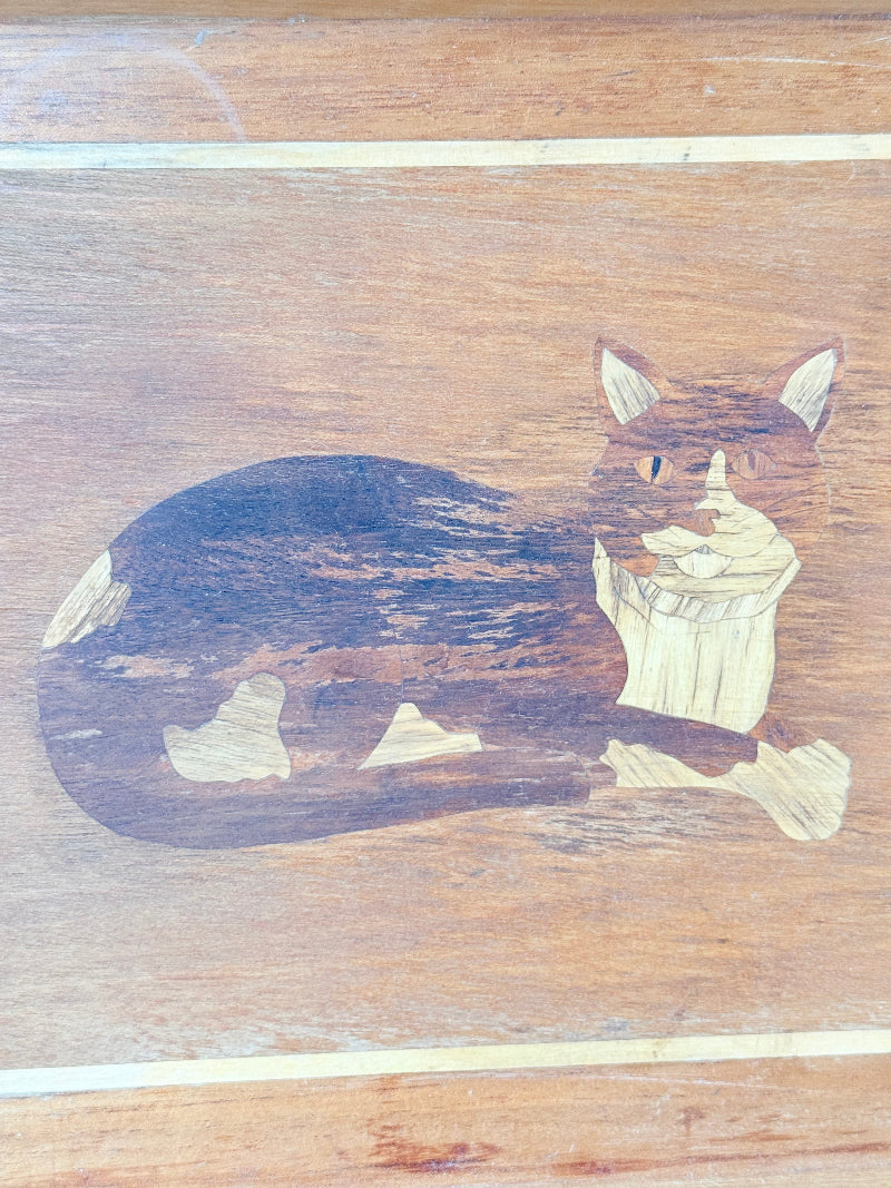 Vintage wooden tray with cat marquetry inlay, photographed on a white surface