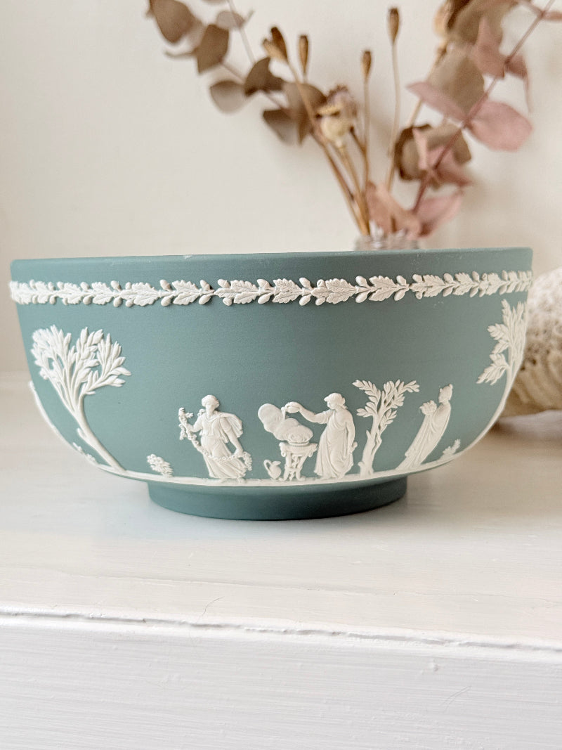Large vintage Wedgwood Jasperware teal green fruit bowl decorated with white classical figures beneath stylised trees and a laurel garland border.