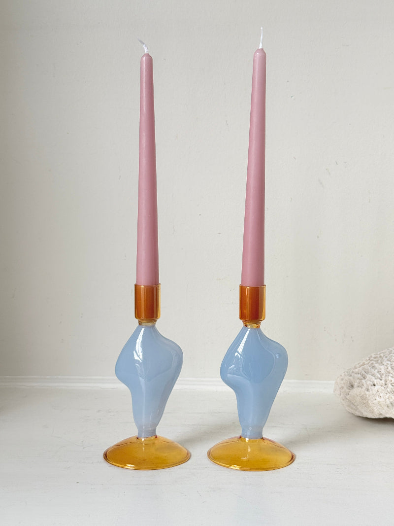 Pair of &amp;Klevering Amsterdam Flux glass candle holders in light blue and amber with pink taper candles