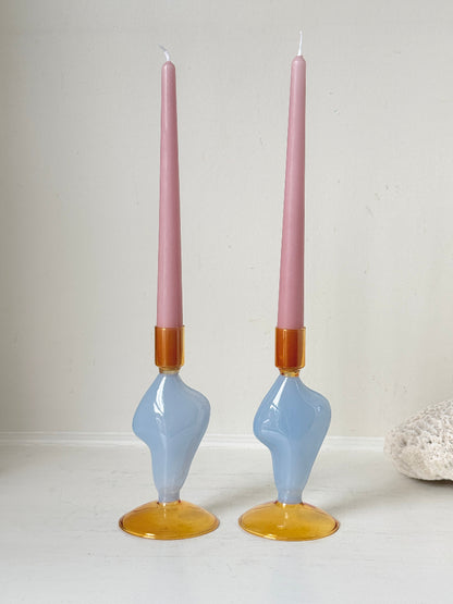 Pair of &amp;Klevering Amsterdam Flux glass candle holders in light blue and amber with pink taper candles