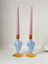 Pair of &Klevering Amsterdam Flux glass candle holders in light blue and amber with pink taper candles