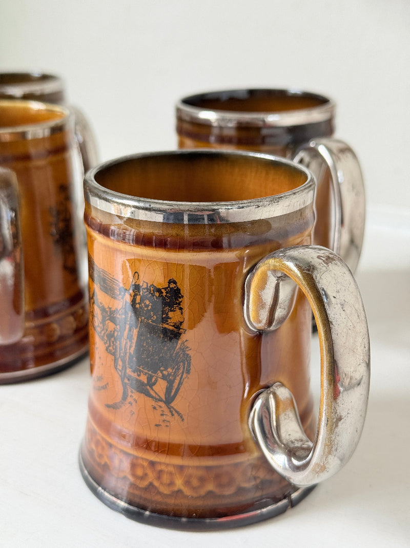 Set of 4 Ridgways stoneware tankard mugs photographed on a white surface in amber brown glaze with black Coaching Days and Coaching Ways transfer scenes