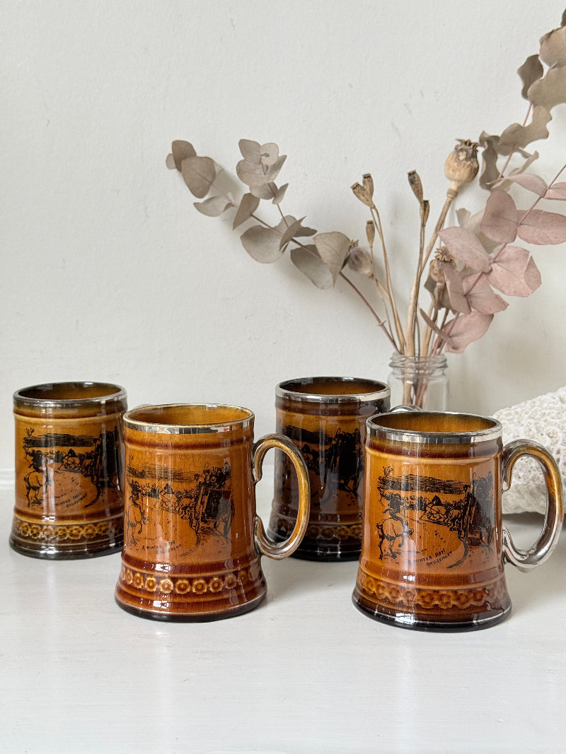 Set of 4 Ridgways stoneware tankard mugs photographed on a white surface in amber brown glaze with black Coaching Days and Coaching Ways transfer scenes