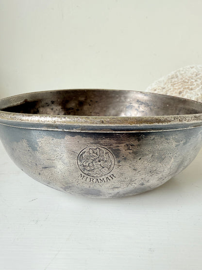 Antique Christofle silver plate bowl with decorative handle, photographed on a white surface.