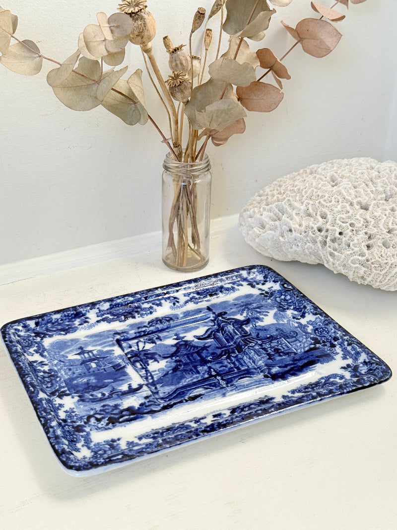 Vintage Wedgwood blue and white rectangular transferware plate with scenic design photographed on a white surface