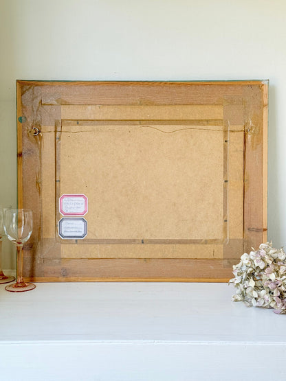 Framed oil painting of Costa del Sol with whitewashed hillside towns, photographed on a white surface