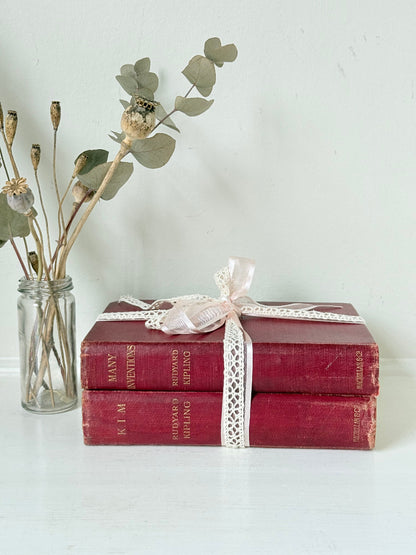 Vintage Rudyard Kipling book bundle of Kim and Many Inventions in red hardback covers, photographed on a white surface