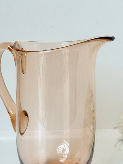 retro apricot glass serving jug with curved handle and flared spout, photographed on white surface