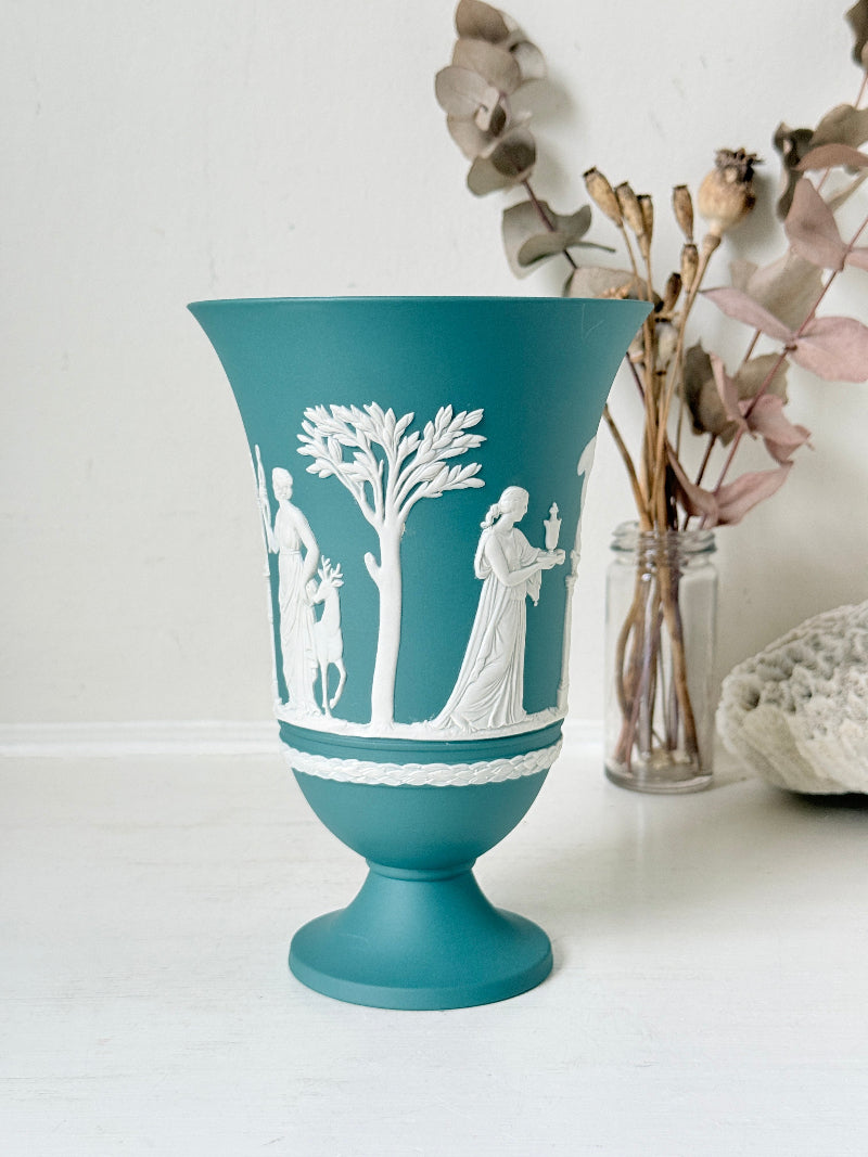 Large vintage Wedgwood Jasperware teal green pedestal vase decorated with white classical Muses figures and stylised trees, styled with dried stems.