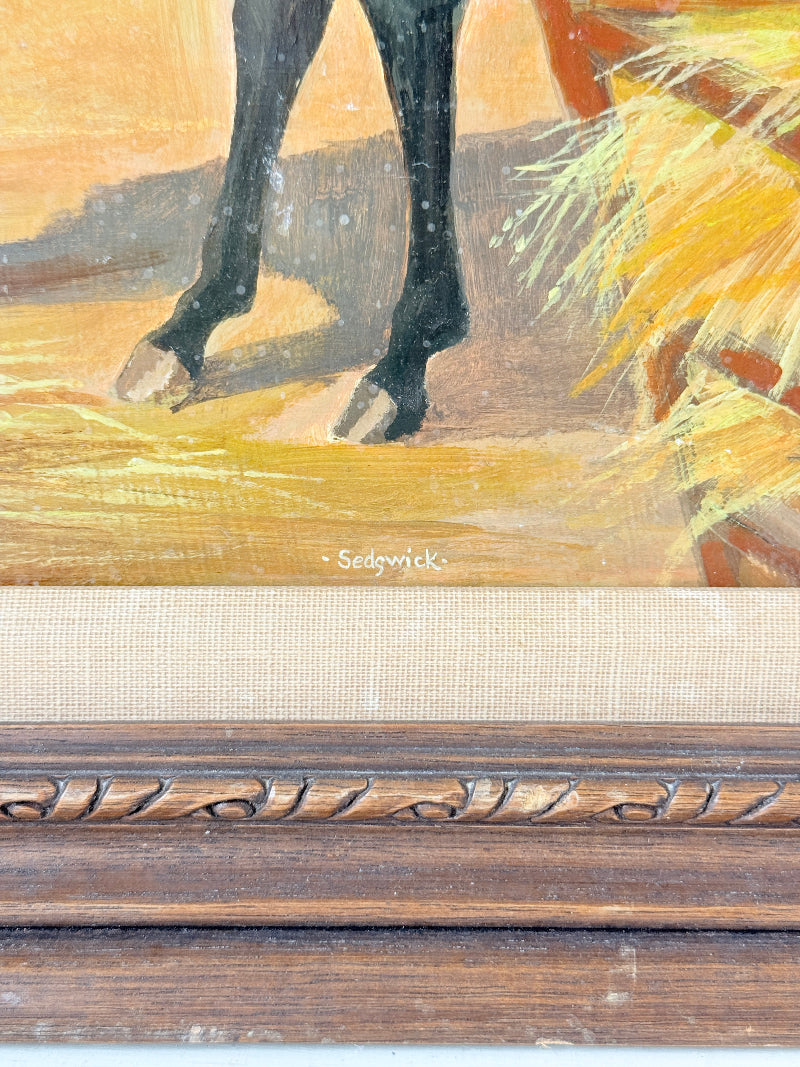 Close-up of a framed painting showing part of a horse&