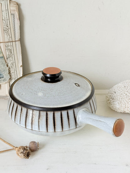 Denby Studio large two handled lidded casserole in grey and rust photographed on a white surface