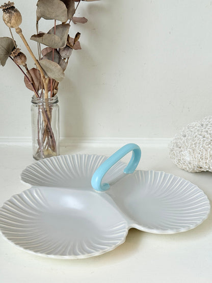 Poole Pottery triple scallop hors d’oeuvre dish in grey glaze with powder blue handle photographed on a white surface