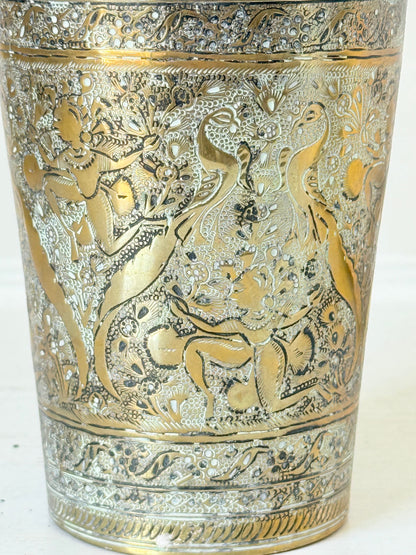 Indian Benares brass jar with lid and engraved animals and floral design, photographed on a white surface
