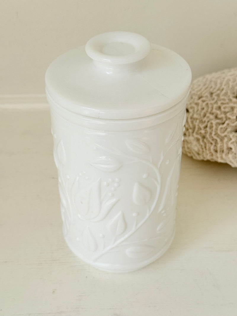 French opale glass jar with floral raised design, white vintage milk glass, shown on white background