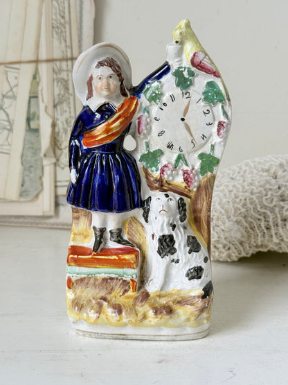 Victorian Staffordshire flatback clock group with girl spaniel and parrot hand painted in cobalt blue and orange