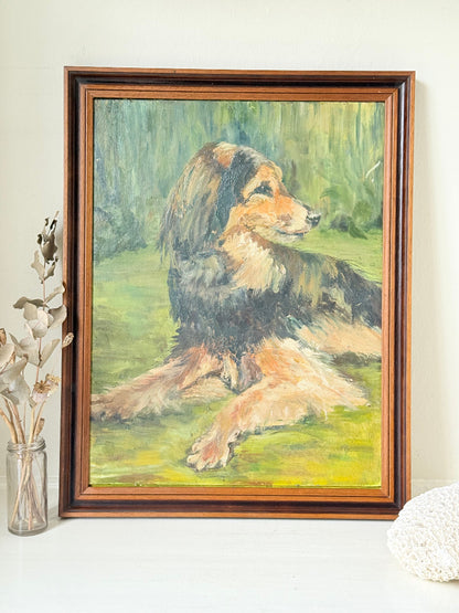 Oil painting of a dog by Muriel Hester Broughton in wooden frame, photographed on white surface.
