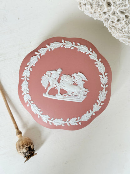 Rare vintage Wedgwood Jasperware round lidded trinket box in terracotta rose pink, with a central classical cameo scene and white laurel wreath border.