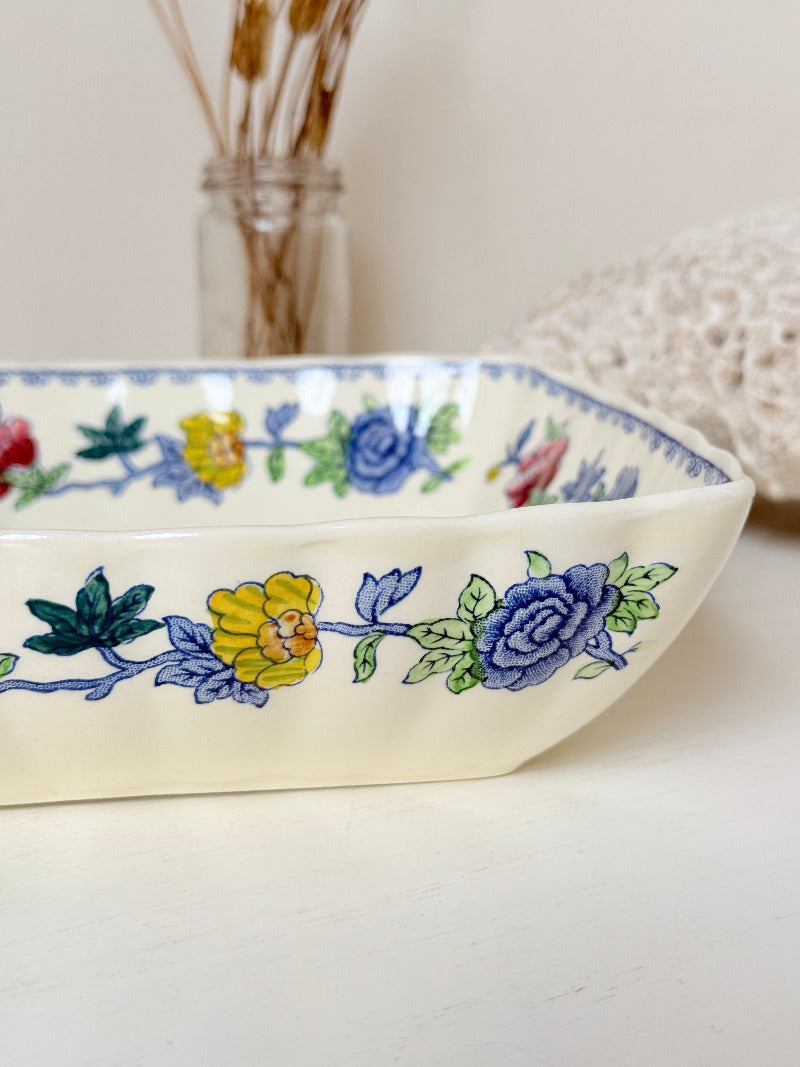 Vintage Mason’s ironstone serving dish with square form and spring floral pattern in blue, pink, yellow, and green, photographed on a white surface