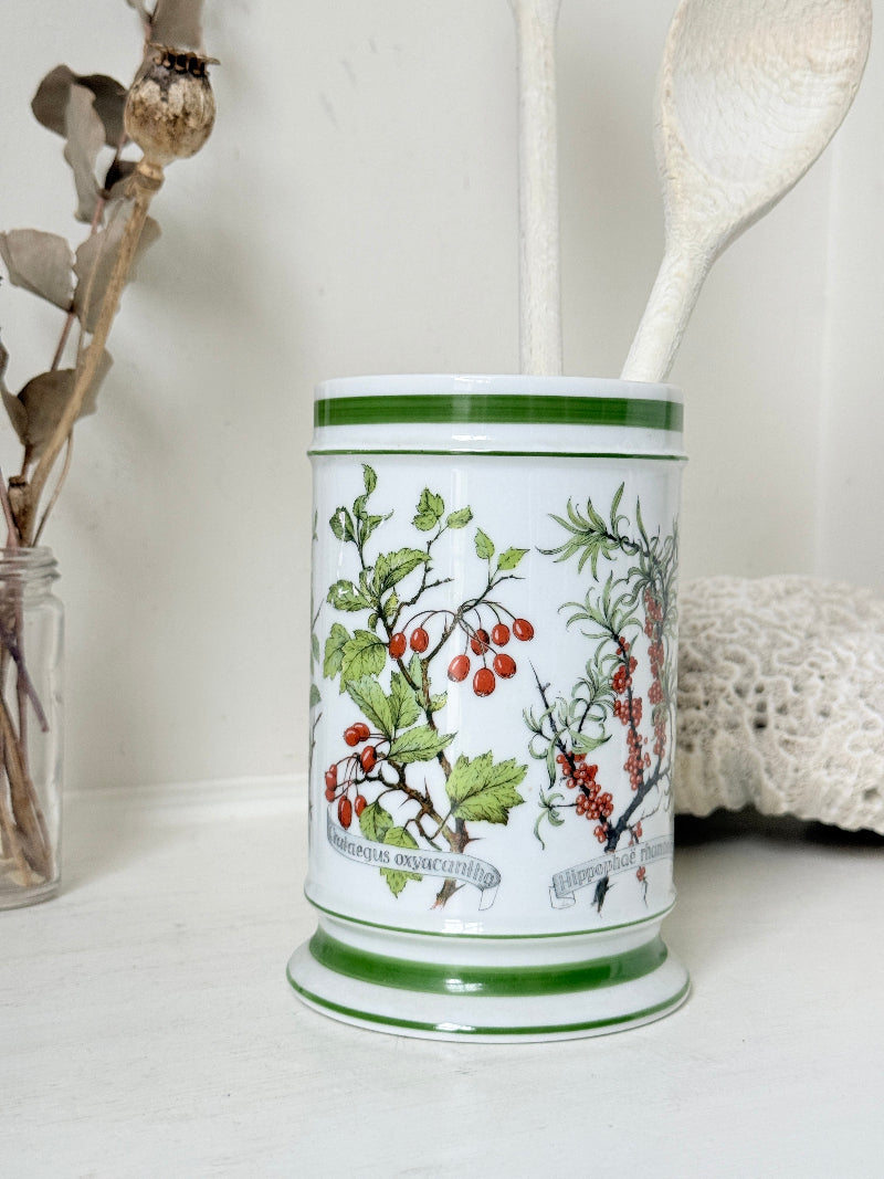 Vintage Kaiser W Germany porcelain utensil jar with botanical floral pattern and green rim photographed on a white surface