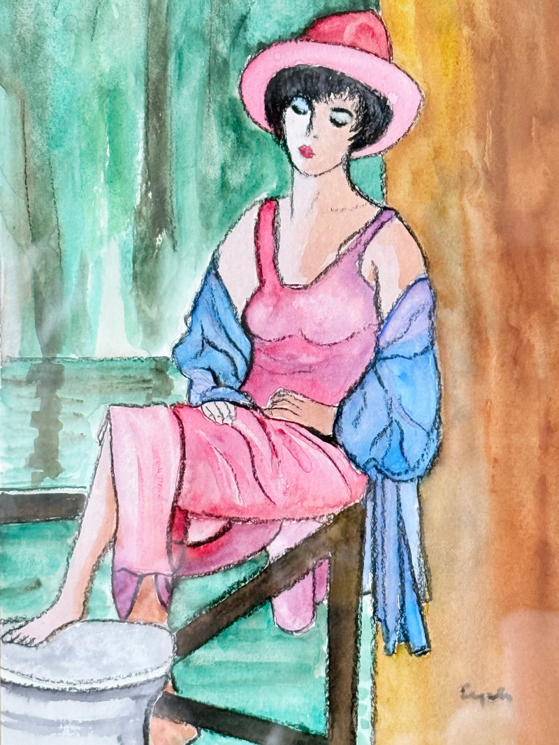 Vintage bright watercolour portrait of a seated woman in pink hat and dress with blue jacket, framed in blue wood with off-white mount, photographed on a white surface.