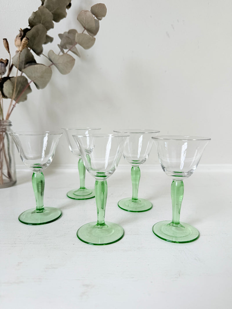 Set of five green stemmed liqueur glasses