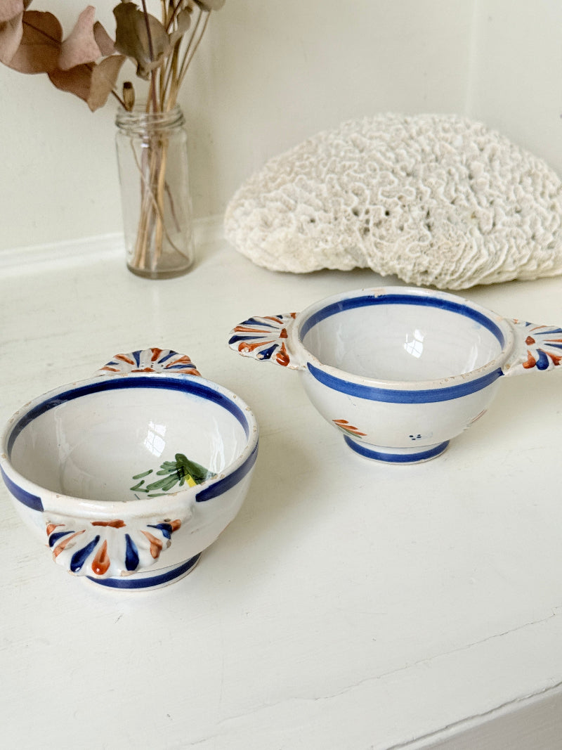 Pair of vintage French Quimper olive bowls with Breton figure and fan handles, photographed on a white surface