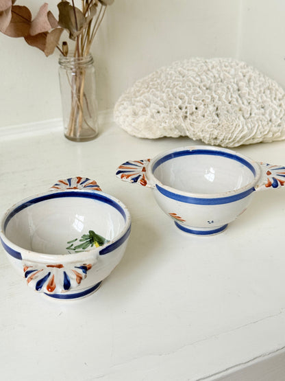 Pair of vintage French Quimper olive bowls with Breton figure and fan handles, photographed on a white surface