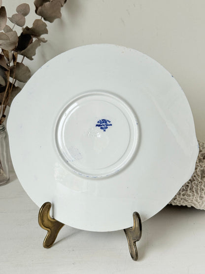 Blue Willow serving plate with cobalt blue transfer pattern shown on a white surface.