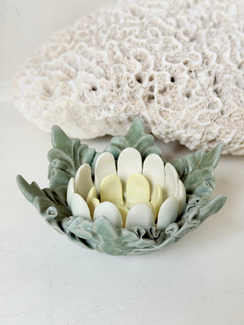 Vintage Chessell Pottery flower bowl in sage green and cream photographed on a white surface