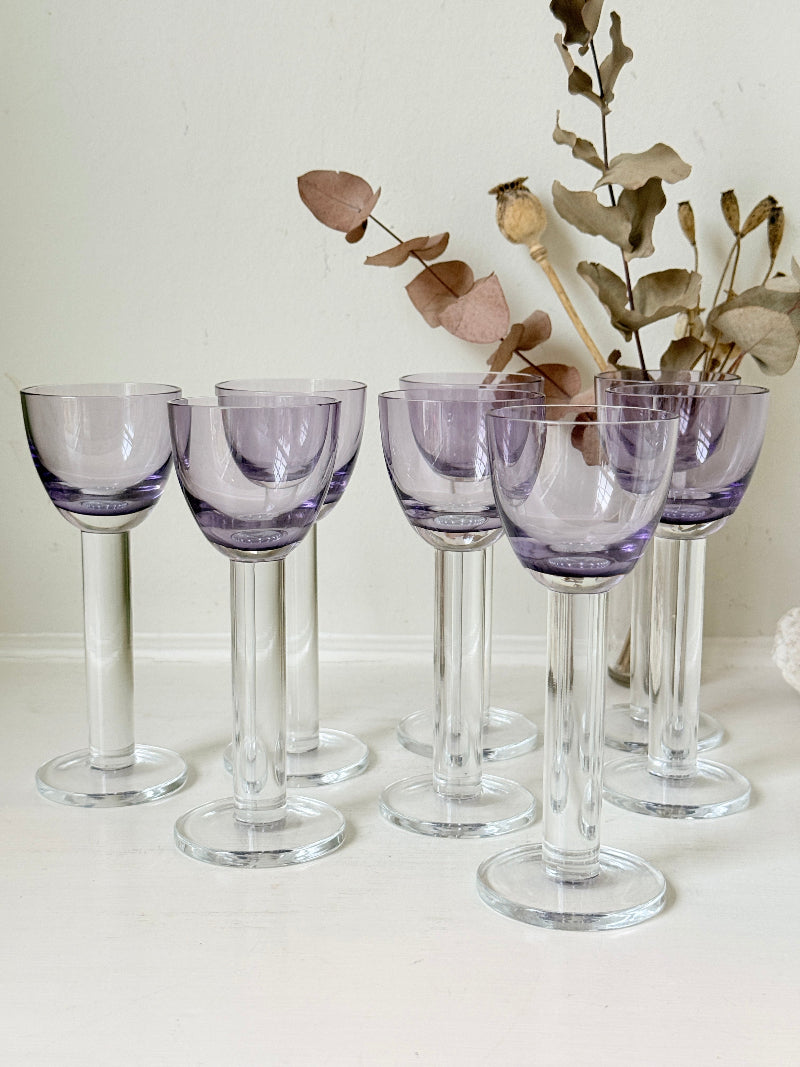 Set of 8 vintage lilac tinted liqueur glasses on a white surface