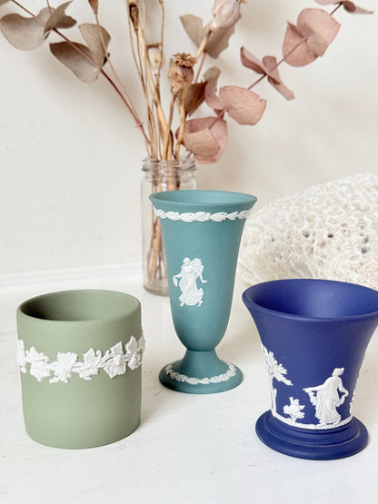 Trio of vintage Wedgwood Jasperware vases in green and blue with white relief decoration, photographed on a white surface