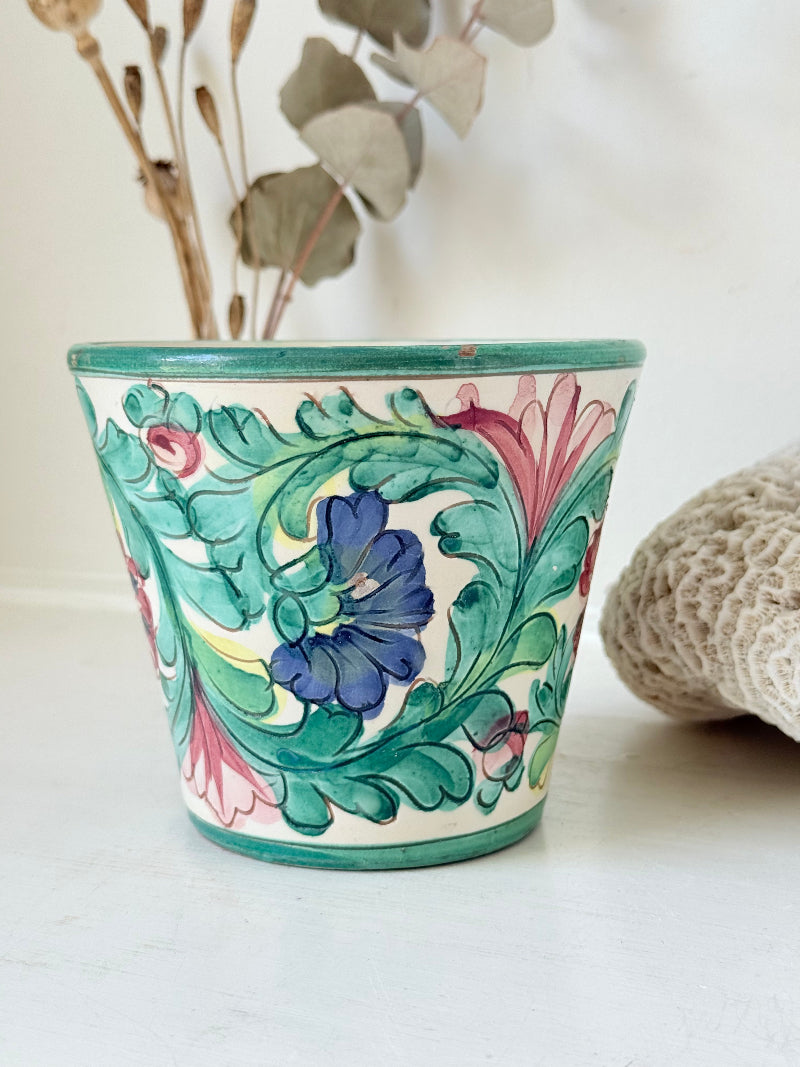 Italian handmade pot with colourful floral decoration, glazed finish, marked base, photographed on white surface.