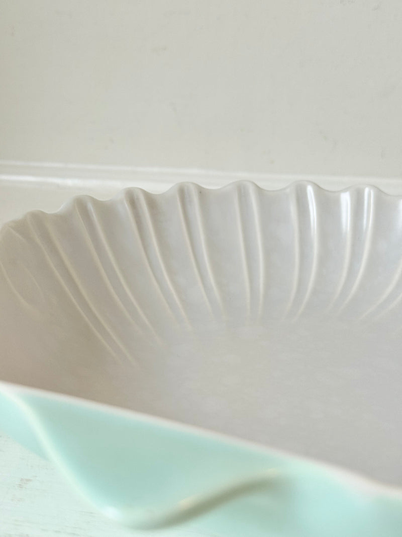 Poole Pottery scallop shell serving dish in white and seafoam glaze photographed on a white surface
