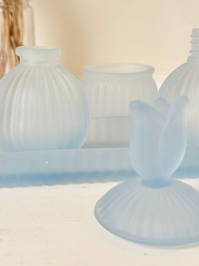 Vintage powder blue frosted glass dresser set with tray and three matching pieces, photographed on a white surface