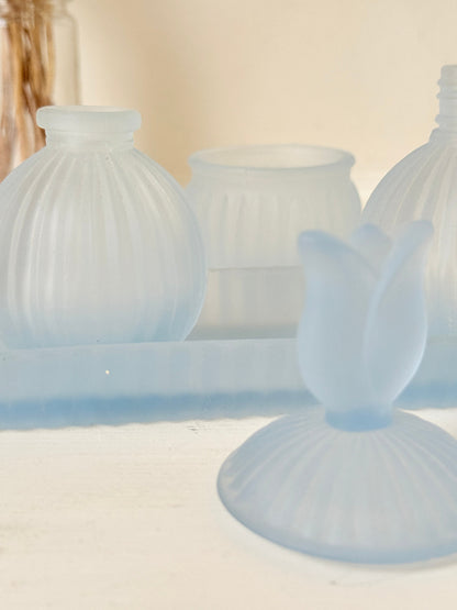 Vintage powder blue frosted glass dresser set with tray and three matching pieces, photographed on a white surface