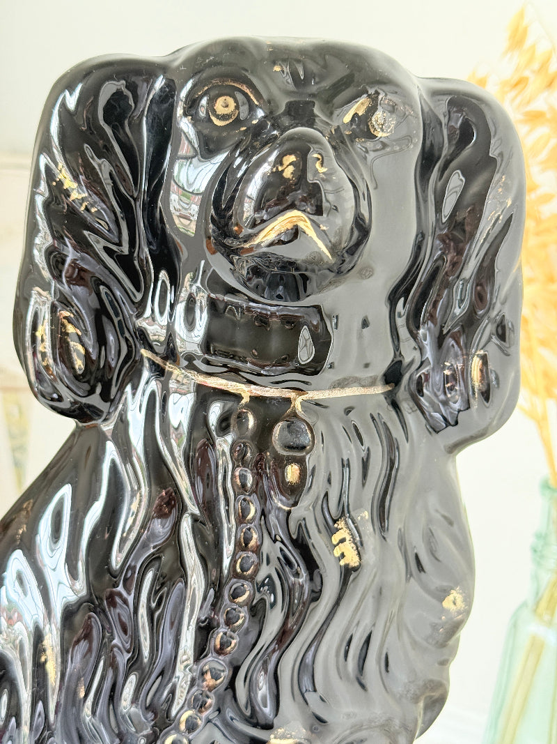 Vintage Staffordshire style black ceramic spaniel dog with gold lustre collar, glossy glaze and textured coat detail