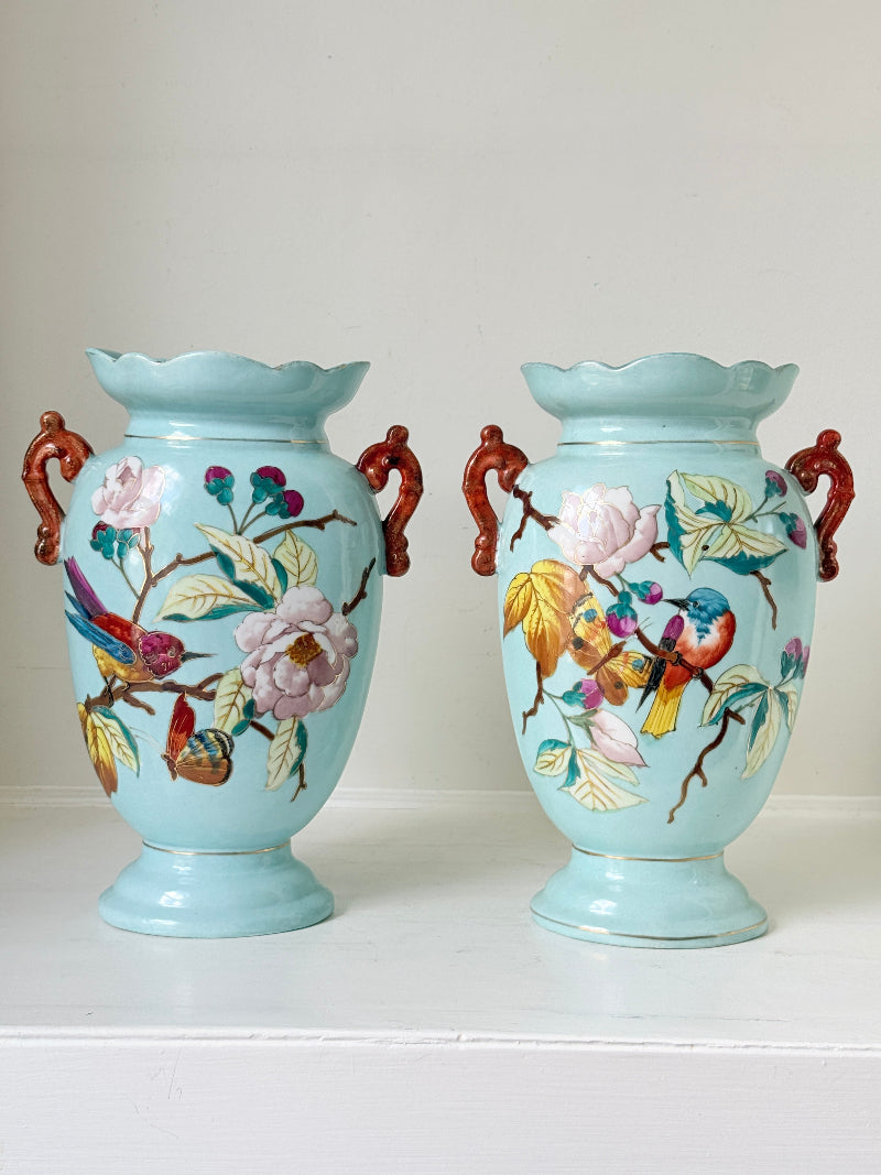 Pair of Paris porcelain Aesthetic Movement vases from the late 1800s, hand painted with birds, blossom and coral handles
