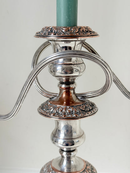 Pair of convertible silver plate on copper candelabra with repoussé detail, removable arms and green taper candles
