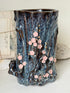 Large ceramic tree trunk vase with applied pink cherry blossom detail, textured bark form and dark drip glaze