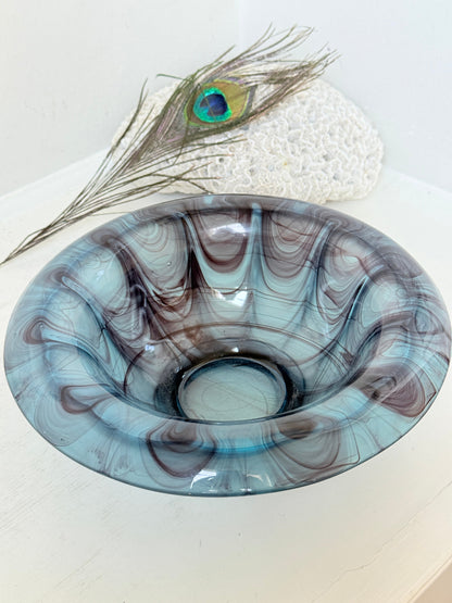 George Davidson blue cloud glass bowl with purple marbled swirls, photographed on a white surface