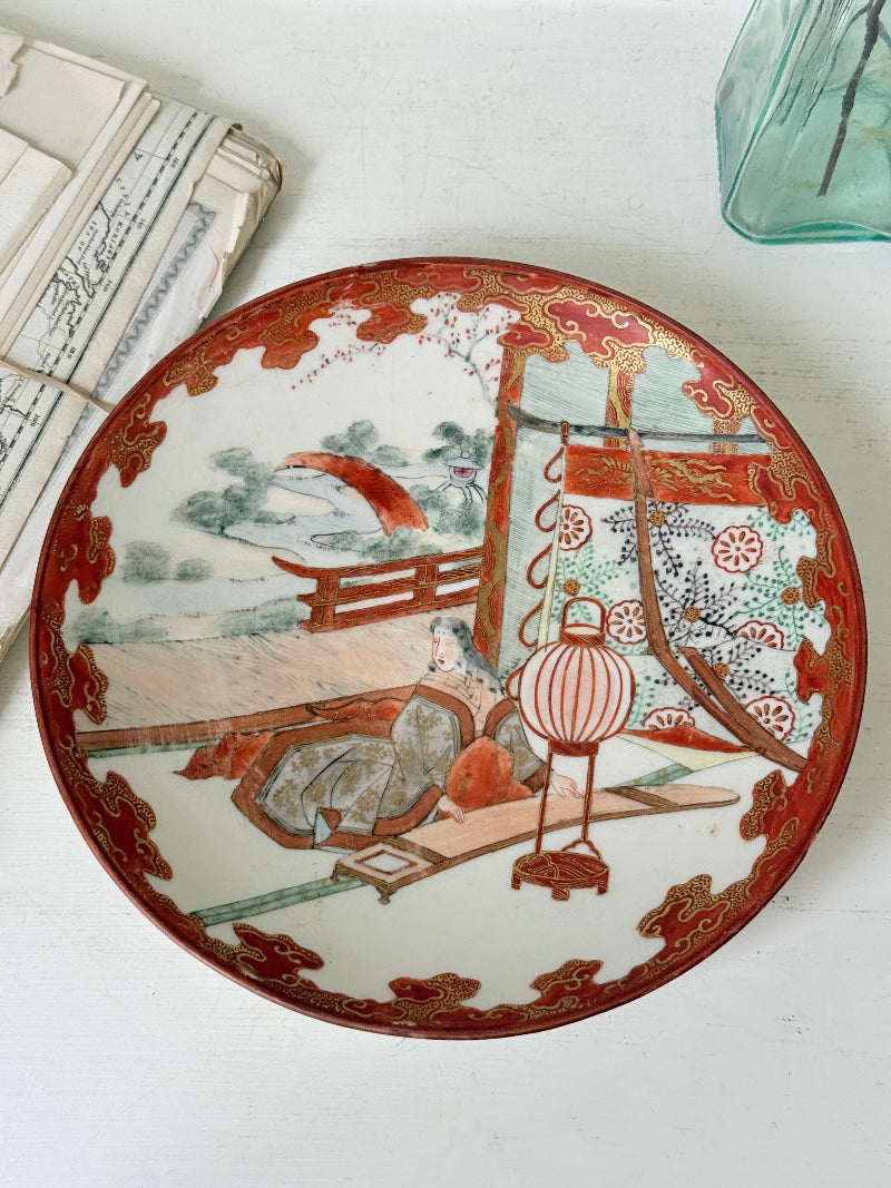 Japanese Kutani porcelain dish hand painted with a garden pavilion scene in iron red and gold
