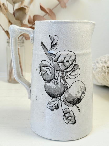 Antique English transferware jug with black fruit and leaf design, photographed on a white surface